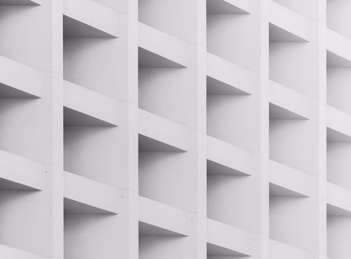 Abstract white geometric pattern with repeating rectangular shapes creating depth and shadows